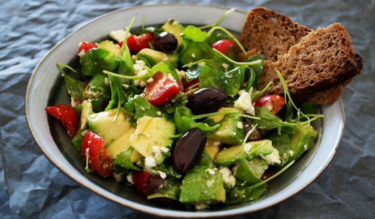 Delicious Greek salad featuring avocado, feta, and olives, ideal for a healthy meal.