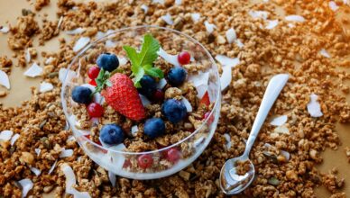 A top view of a healthy granola breakfast with fresh berries and yogurt in București.