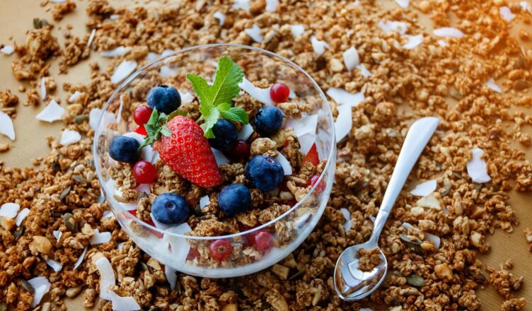 A top view of a healthy granola breakfast with fresh berries and yogurt in București.