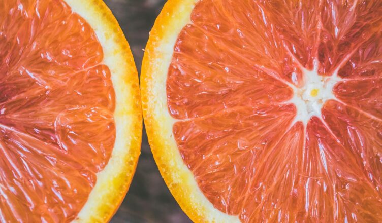 Detailed close-up of fresh grapefruit slices showcasing vibrant colors and textures.