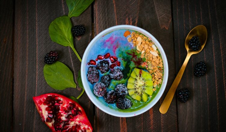 mixed fruits on bowl with blueberry on top